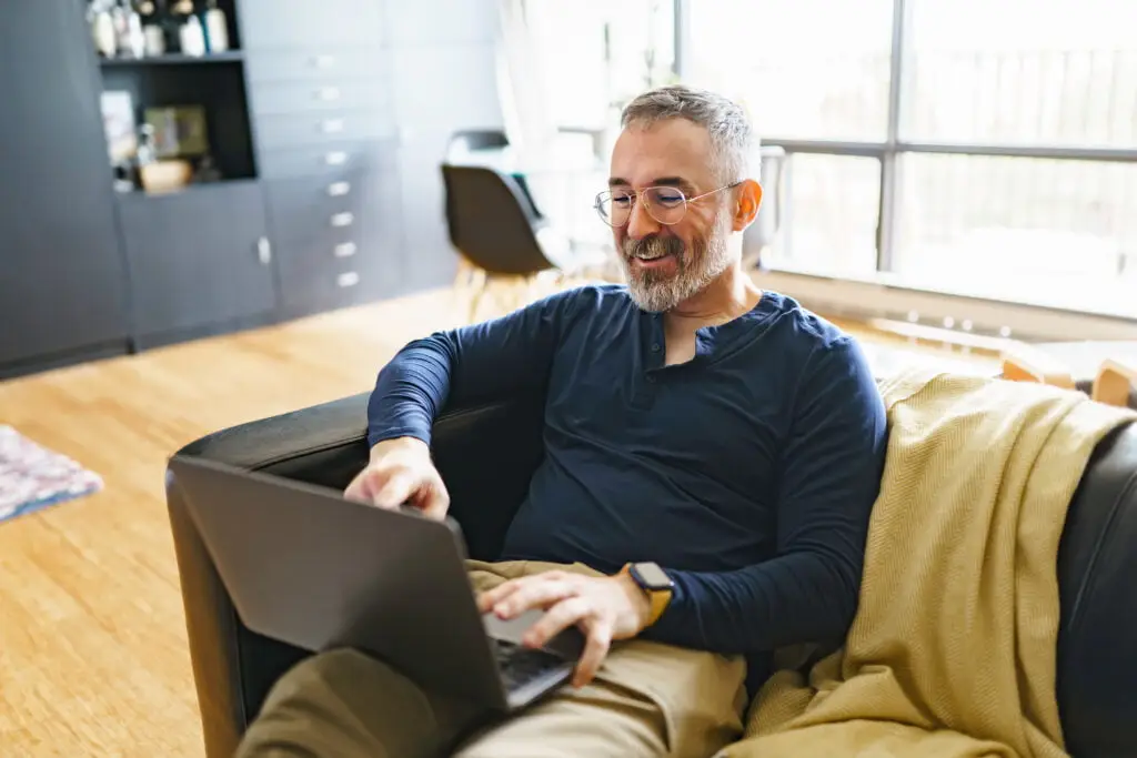 Man attending virtual therapy at home